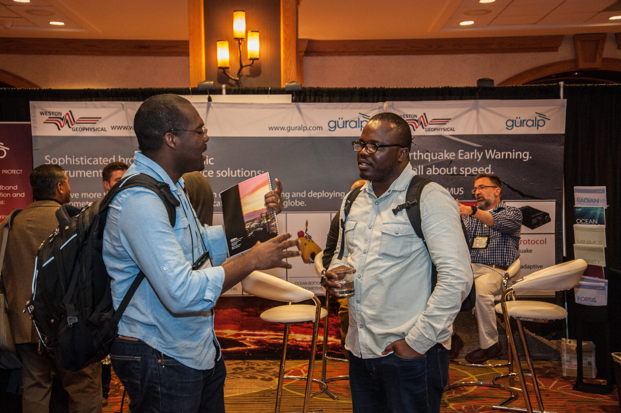 A presenter explains a poster to a colleague at the SSA Annual Meeting 2023