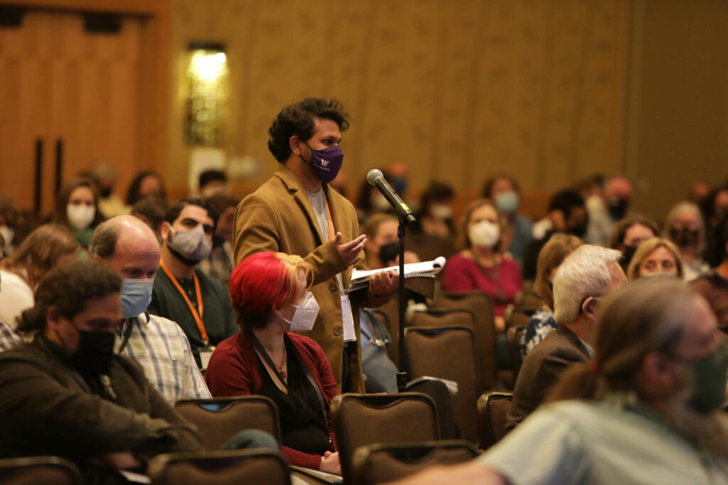 A scientist wearing a mask asking a question at the SSA Annual Meeting 2022