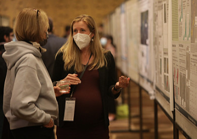 A poster presenter talking with a colleague at the SSA Annual Meeting 2023