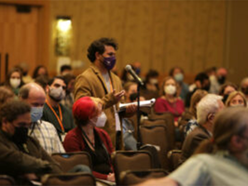 A scientist wearing a mask asking a question at the SSA Annual Meeting 2022
