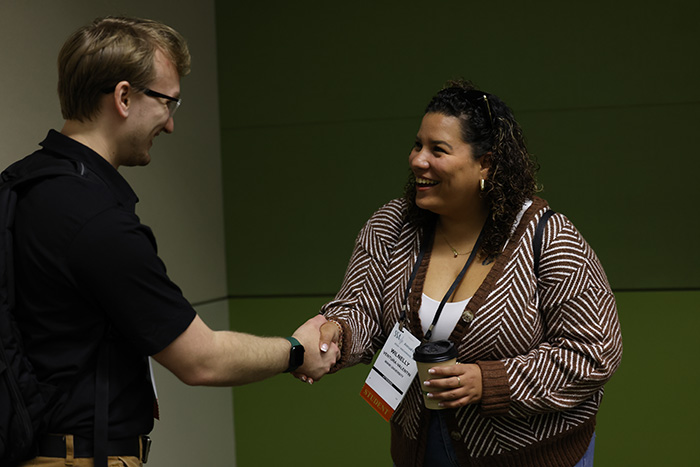 SSA Annual Meeting Attendees Shake Hands